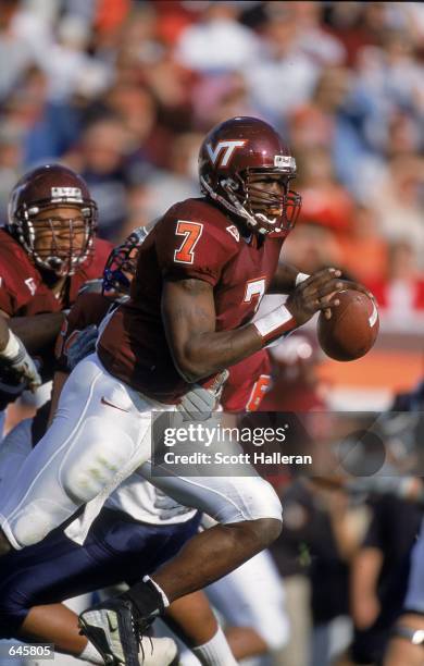 Michael Vick of the Virginia Tech Hokies runs with the ball during the game against the Pittsburgh Panthers at Blacksburgh, Virginia. The Hokies...