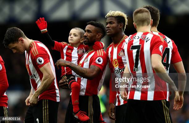Sunderland mascot Bradley Lowery waves to the crowd as Jermain Defoe looks on ahead of the Premier League match between Everton and Sunderland at...