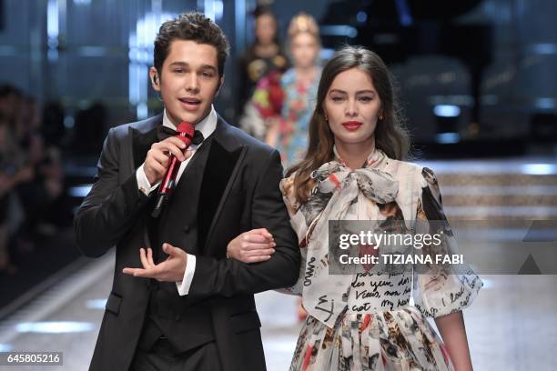 Model Marie-Ange Casta walks the runway with singer Austin Mahone during the show for fashion house Dolce & Gabbana during the Women's Fall/Winter...