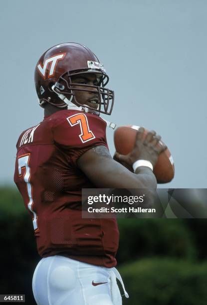 Michael Vick of the Virginia Tech Hokies looks to pass during the game against the Pittsburgh Panthers at Blacksburgh, Virginia. The Hokies defeated...