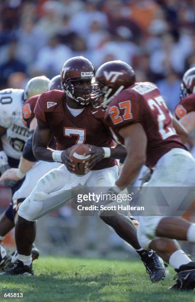 Michael Vick of the Virginia Tech Hokies moves to hand off the ball during the game against the Pittsburgh Panthers at Blacksburgh, Virginia. The...