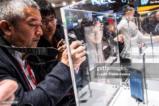 Visitors look at the new Sony Xperia XZ during the Mobile World Congress 2017 on the opening day of the event at the Fira Gran Via Complex on...