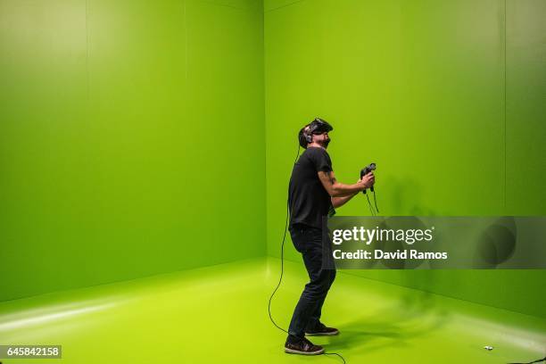 Visitor enjoys a HTC VR virtual reality experience during the Mobile World Congress 2017 on the opening day of the event at the Fira Gran Via Complex...