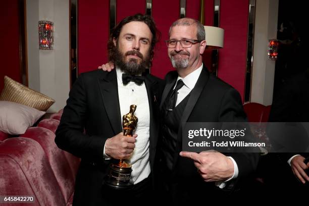 Actor Casey Affleck with his award for best actor in 'Manchester By The Sea' and Keith Simanton attend the Amazon Studios Oscar Celebration at...