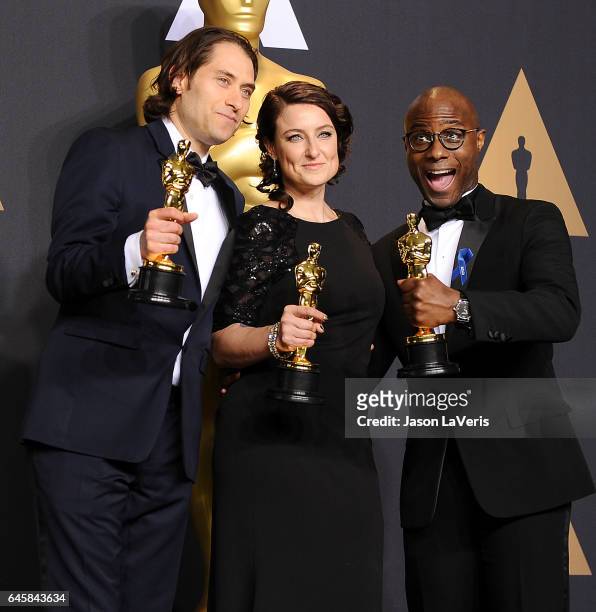 Producers Jeremy Kleiner and Adele Romanski , winners of the award for Best Picture for 'Moonlight,' pose with filmmaker Barry Jenkins in the press...