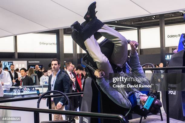 Visitors enjoy a Samsung VR virtual reality experience during the Mobile World Congress 2017 on the opening day of the event at the Fira Gran Via...