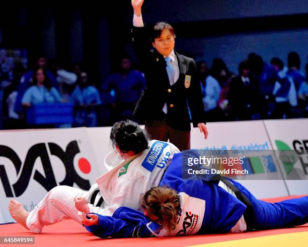 The referee indicates ippon as Iryna Kindzerska of the Ukraine holds Kristin Buessow of Germany to reach the o78kg final and the gold medal during...
