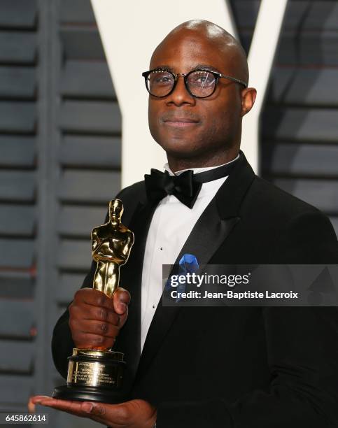 Writer/director Barry Jenkins poses with the Best Adapted Screenplay award for 'Moonlight' he arrives to the Vanity Fair Party following the 88th...