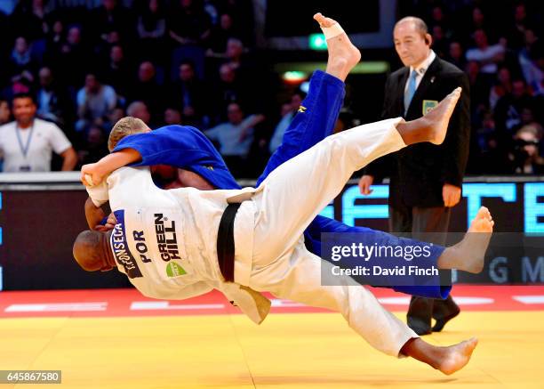 Jorge Fonseca of Portugal throws Philipp Galandi of Germany cleanly onto his back with a sacrifice technique for an ippon to win their u100kg contest...