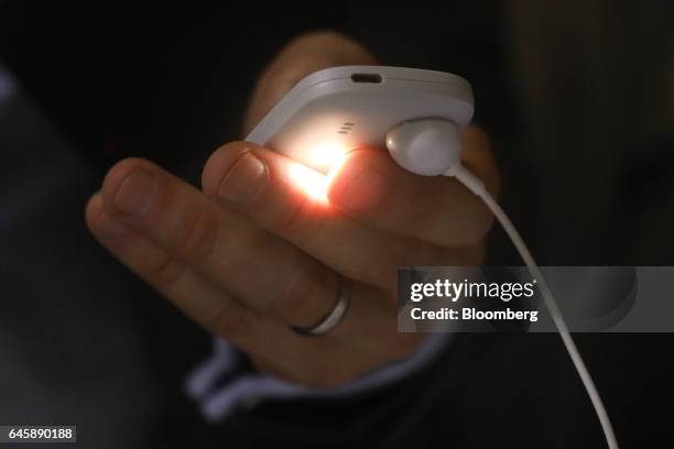 An attendee uses the torch feature on a Nokia 3310 mobile phone, manufactured by HMD Global Oy, on the opening day of the Mobile World Congress in...