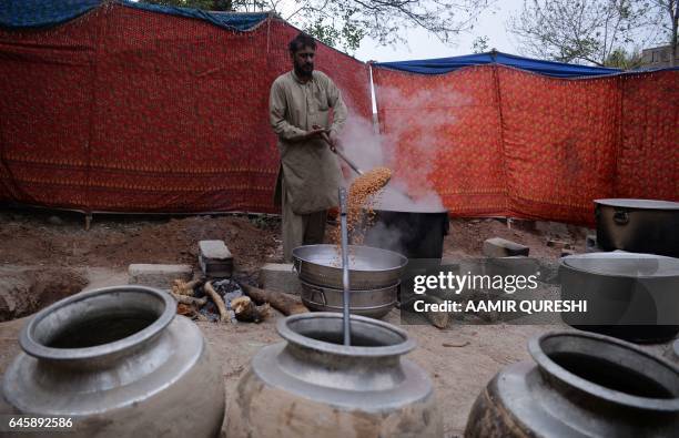 Pakistan cook prepares food for a follower of Mumtaz Qadri, near the tomb of Qadri, who was hanged last year for the murder of a governor who...
