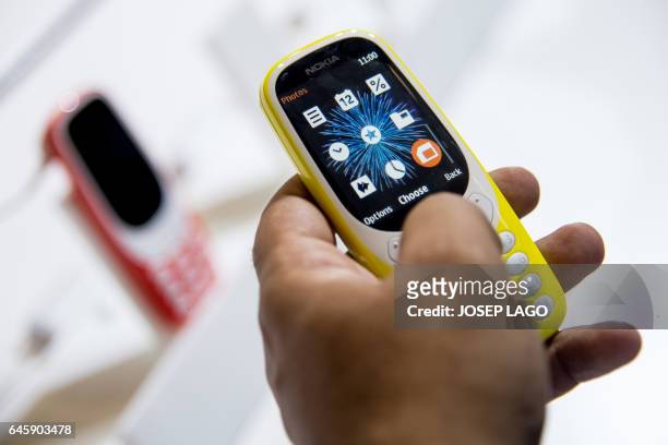 Person tests the new "Nokia 3310" model of Finnish HMD global at the Mobile World Congress on the first day of the MWC in Barcelona, on February 27,...