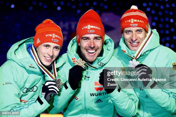 Eric Frenzel of Germany wins the silver medal, Johannes Rydzek of Germany wins the gold medal, Bjoern Kircheisen of Germany wins the bronze medal...