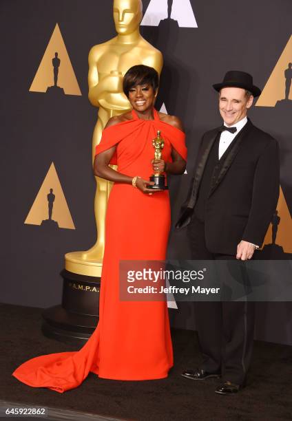 Actress Viola Davis , winner of the award for Actress in a Supporting Role for 'Fences,' poses with presenter actor Mark Rylance in the press room...