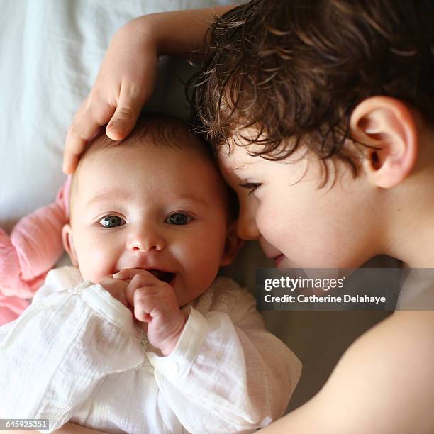 a baby girl and her big brother - siblings baby stock pictures, royalty-free photos & images