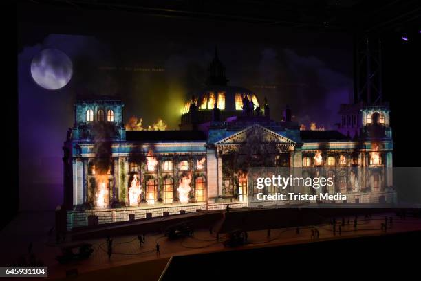 Model of the Reichstag is overlayed with an animated video of flames and smoke as model figures look on in a representation of the Reichstag fire of...