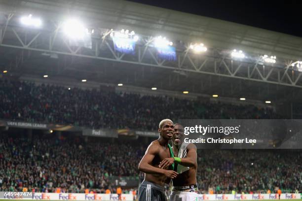 Paul Pogba of Manchester United swaps shirts and jokes with his brother Florentin Pogba of Saint-Etienne during the UEFA Europa League Round of 32...