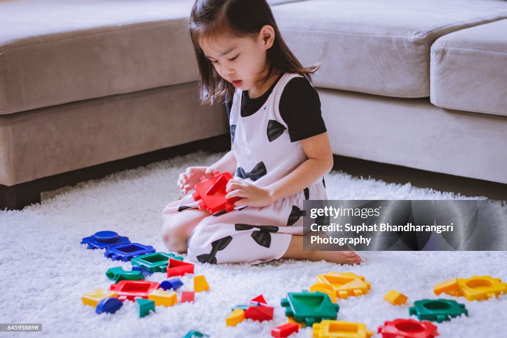 Toddler choosing a toy block