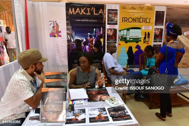 People attend the 18th international African television and cinema fair on the sidelines of the Pan-African Film and Television Festival in...