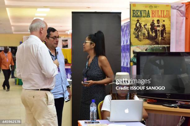 People attend the 18th international African television and cinema fair on the sidelines of the Pan-African Film and Television Festival in...