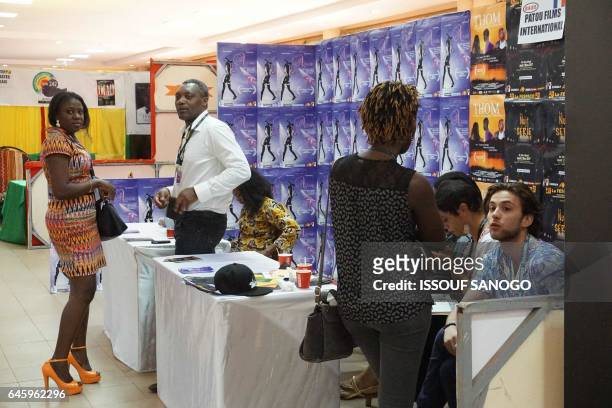 People attend the 18th international African television and cinema fair on the sidelines of the Pan-African Film and Television Festival in...