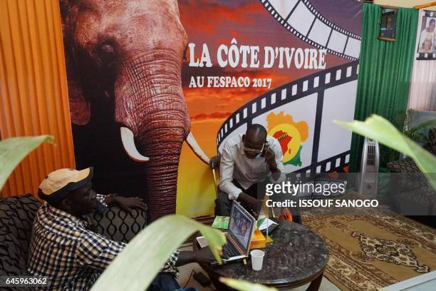 People attend the 18th international African television and cinema fair on the sidelines of the Pan-African Film and Television Festival in...