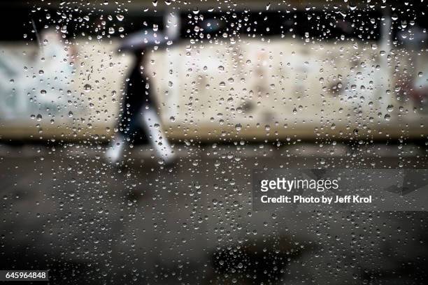 blurred rain view from a person through a rainy window with raindrops - druppel photos et images de collection