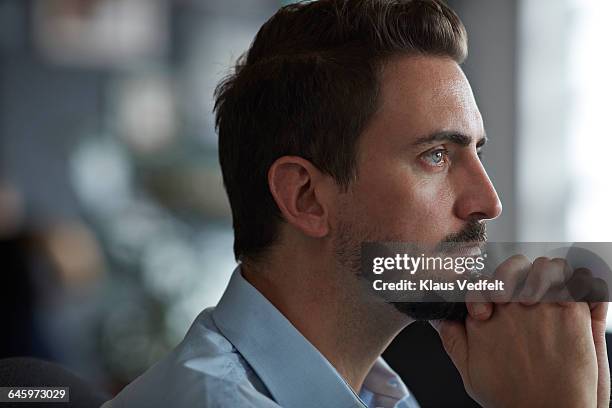portrait of businessman looking out of window - blue eyes man stock pictures, royalty-free photos & images