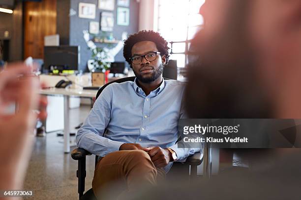 portrait of businessman listening to co-worker - two people talking serious stock pictures, royalty-free photos & images