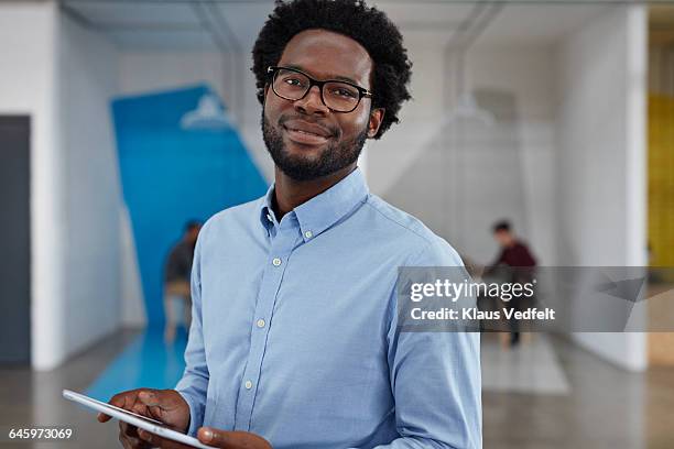 businessman smiling and holding tablet - black shirt stock pictures, royalty-free photos & images