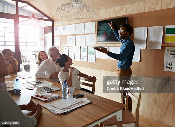 man doing presentation, using tablet & screen - テレビ　会議 ストックフォトと画像