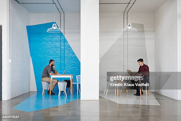 businesspeople sitting in booths,working on laptop - office table side view stock pictures, royalty-free photos & images
