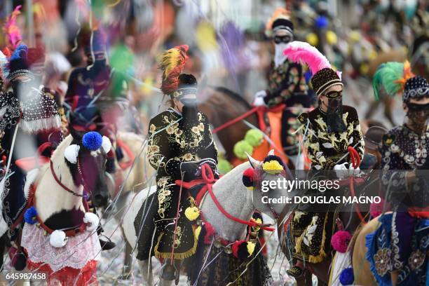 Revellers participate in the traditional carnival on horseback in Bonfim, Minas Gerais state, southeastern Brazil, on February 27, 2017. Dressed in...