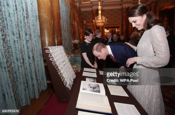 Catherine, Duchess of Cambridge and Prince William, Duke of Cambridge look at a shawl given to Queen Elizabeth II by Mahatma Gandhi at a reception to...