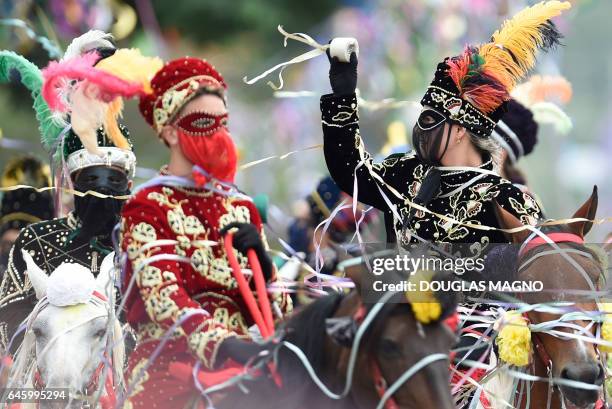 Revellers participate in the traditional carnival on horseback in Bonfim, Minas Gerais state, southeastern Brazil, on February 27, 2017. Dressed in...