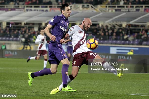 Nikola Kalinic of ACF Fiorentina battles for the ball with Arlind Ajeti of FC Torino during the Serie A match between ACF Fiorentina and FC Torino at...