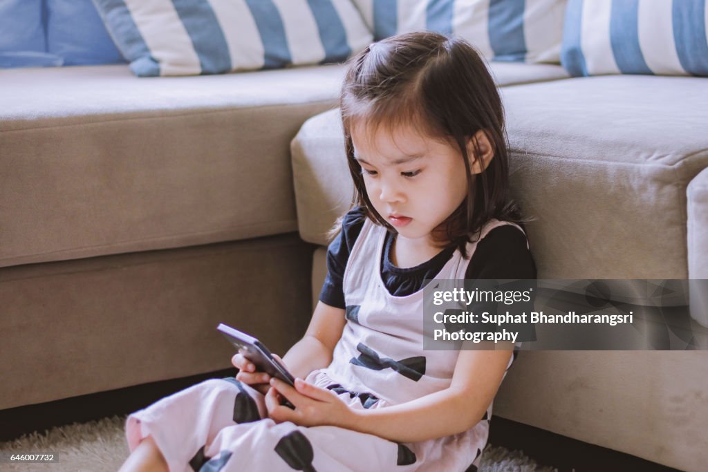 Toddler watching a cartoon smartphone screen