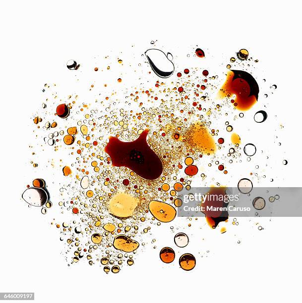 oil and vinegar droplets on white background - food stain stock-fotos und bilder