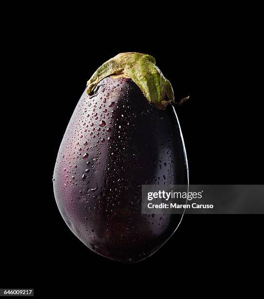 eggplant on black background - aubergine stock-fotos und bilder