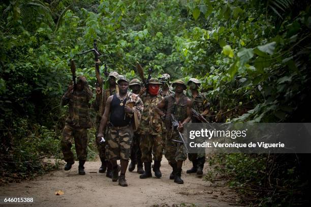 Ateke Tom, the big chief of the MEND , with his recruits, in one of the eleven camps he rules in the mangroves of the Niger delta.