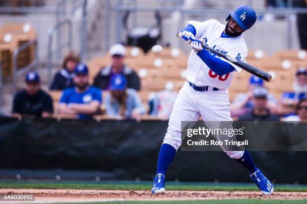 Andrew Toles of the Los Angeles Dodgers singles in the second inning during a spring training game against the Colorado Rockies at Camelback Ranch on...