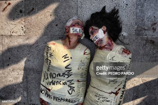 Spanish artist and activist aka "Jil Love" and Mexican activist Julia Klug perform during a protest against femicides in Mexico City on February 27,...