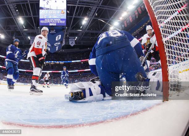 Goalie Andrei Vasilevskiy of the Tampa Bay Lightning lets the puck slip by for a goal for Mark Stone and Derick Brassard of the Ottawa Senators...