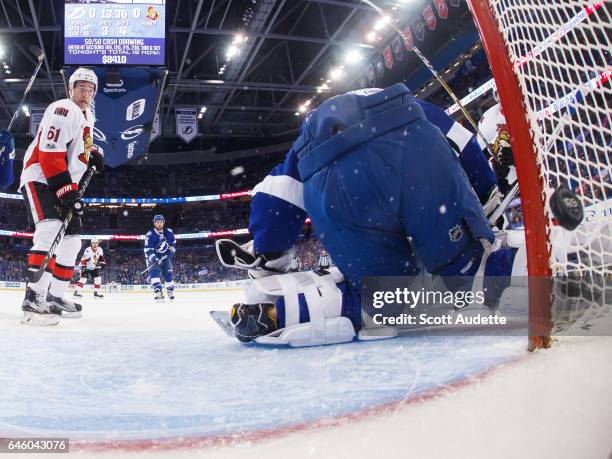 Goalie Andrei Vasilevskiy of the Tampa Bay Lightning lets the puck slip by for a goal for Mark Stone and Derick Brassard of the Ottawa Senators...