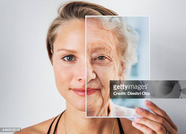 young woman holding picture of elderly woman - 老化過程 個照片及圖片檔