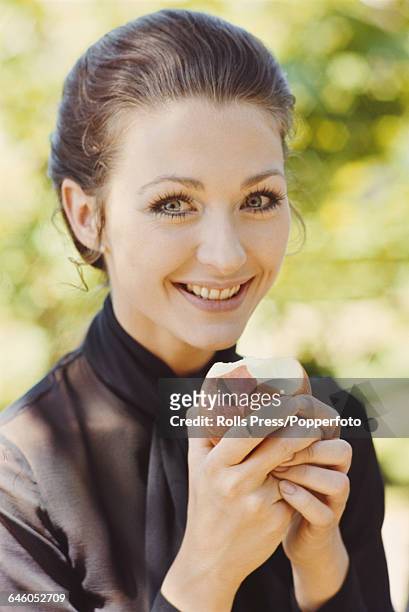 German actress Christine Kaufmann pictured eating an apple in 1969.