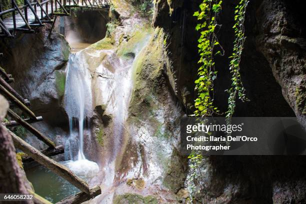 fregona (treviso, italy), aprile 2016: waterfalls on the footpath in caglieron cave. - fregona stock pictures, royalty-free photos & images