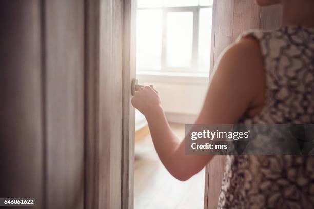 girl walking through door - entering stock pictures, royalty-free photos & images