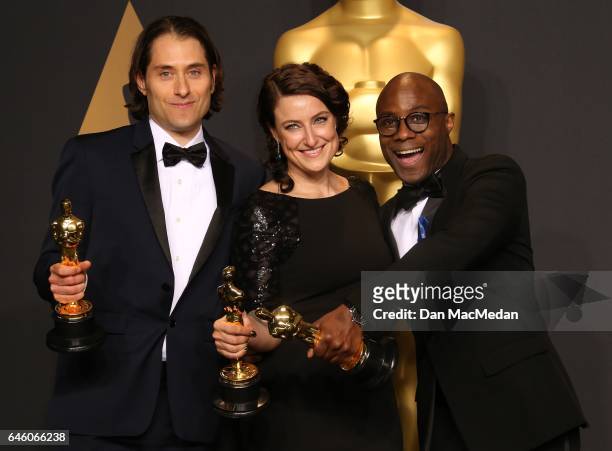 Jeremy Kleiner, Adele Romanski and Barry Jenkins pose in the press room with award for Best Picture for 'Moonlight,' at the 89th Annual Academy...