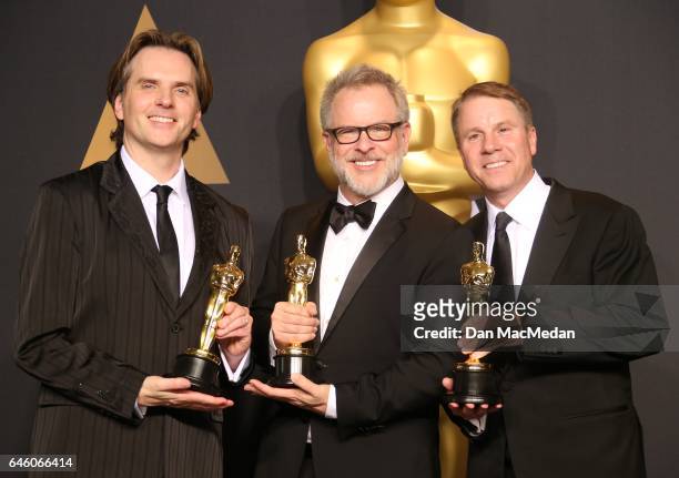 Co-directors Byron Howard and Rich Moore and producer Clark Spencer, winners of the Best Animated Feature Film award for 'Zootopia,' pose in the...